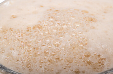 background of foam of dark beer close up