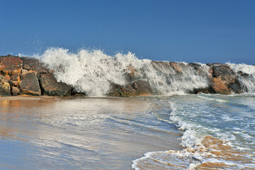 Droplets of water projected by the crashing of waves against the rocks