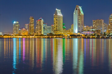 City at night, panoramic scene of downtown reflected in water, San Diego, CA, USA