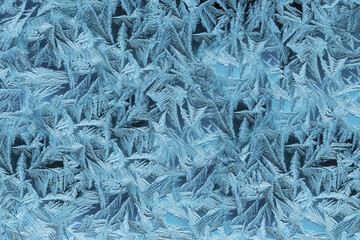 Textured patterns are drawn by frost on the windows of houses