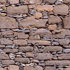 Seamless texture. Background of brown stones of different shapes. Wall of stacked stones.Textured background, close-up.