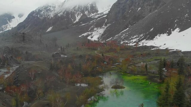 Aerial Over Green Satrangi Lake At Naltar Valley In Pakistan. Dolly Forward