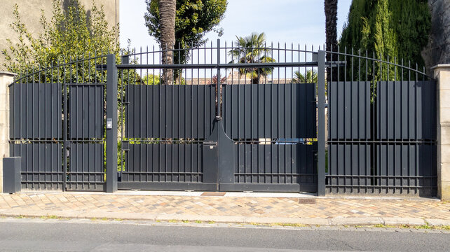 black classical old-fashioned high metal gate of a bourgeois house in europe