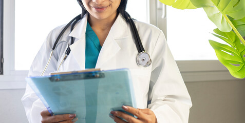 smiling latin doctor with agenda