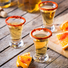 Mexican mezcal or mescal shot with chili pepper and orange