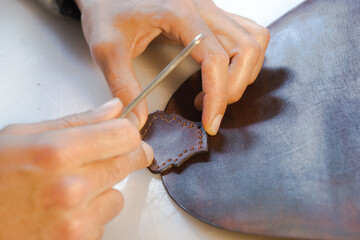 Handmade handicraft leather bag sewing process. Glue working with leather - obrazy, fototapety, plakaty