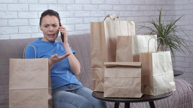 Wrong delivery address. A woman shout with a delivery service on telephone because of wrong bags.