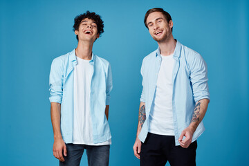 friends in identical clothes on blue background gesturing with hands cropped view