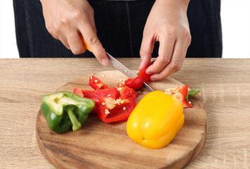 Chef chopped bell pepper on wooden cutting board
