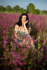 Girl in a turquoise dress in a blooming field