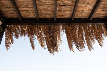 Lounge pavilion for relax with tent made of dry palm leaves. Luxury summer vacation in tropical...