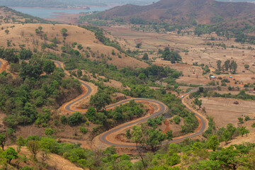 Obraz premium Winding Vishalgad roads near Gelavade Dam, Ratnagiri, Maharashtra, India.