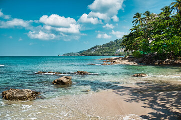 Empty, calm sandy crescent Kalim Bay, Beach with turquoise blue clear water and cirrus cloudy sky