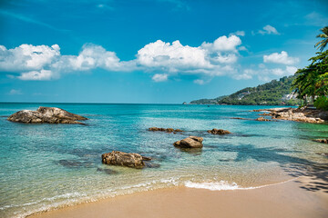 Empty, calm sandy crescent Kalim Bay, Beach with turquoise blue clear water and cirrus cloudy sky