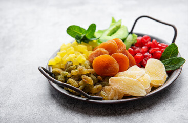 Metal tray with different types of dried fruits