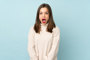 Teenager girl isolated on blue background with surprise facial expression