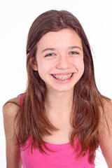 Beautiful young teen girl with brackets on teeth in white