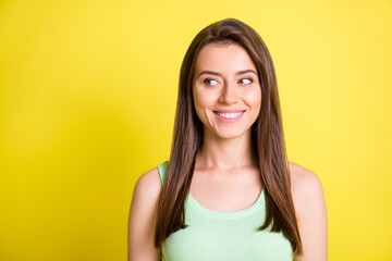 Photo of charming lady look side empty space shiny smile wear green top isolated yellow color background