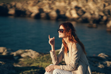 pretty woman at sunset in summer near the sea in the mountains cropped view