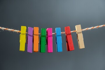 Concept colored wooden clothespins on a ropeclip wooden. color pink.