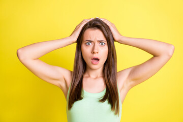 Photo of shocked troubled scared lady hands head open mouth wear green top isolated yellow color background