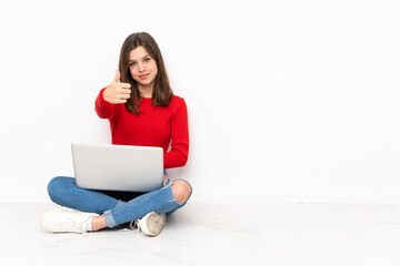 Tenaager girl working with pc isolated on white background with thumbs up because something good has happened