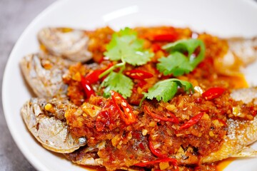 Deep fried fish and chili sauce on white plate delicious and favorite food in Thailand 