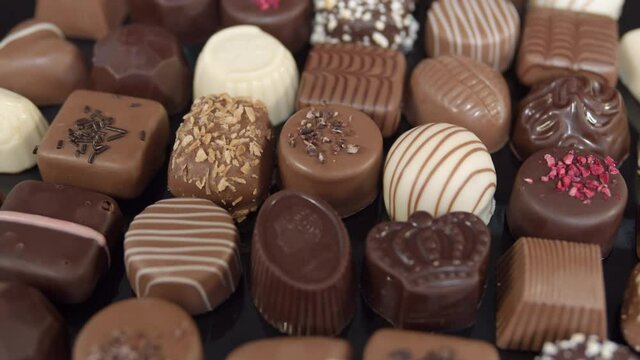 Bonbon chocolates pralines rotating, decorative sweets spinning, valentines holiday gift.