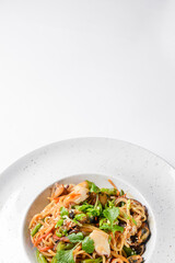 Sea food wok stir fry served in a white plate. Clams and shrimps wok isolated on white.