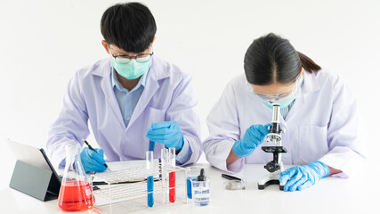 Team of Medical Research Scientists or researcher in lab coat testing their experimental in Modern...