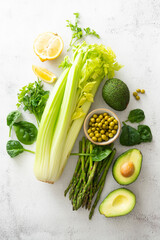 Set of raw green vegetables avocado, asparagus, spinach, letuce, celery. Healthy vegan food concept.