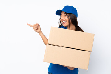 Young delivery brunette girl over isolated white background pointing finger to the side and...