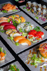 Top view of variety of Japanese dishes on dark background. Vertical image