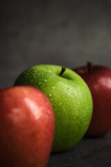 three apples on a dark background