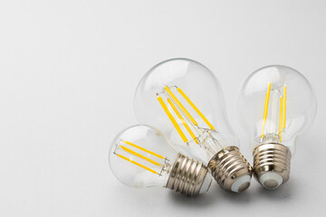 Light bulb on light grey paper background