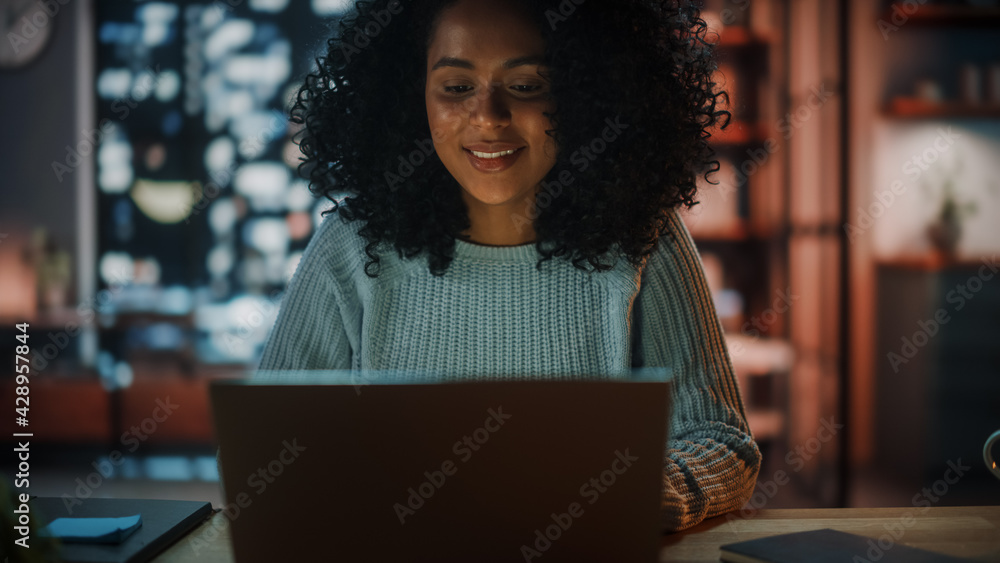 Aufkleber beautiful authentic latina female sitting at a desk in a cozy dark living room in the evening and us