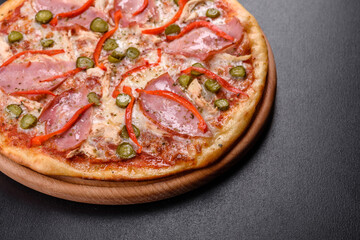 Delicious fresh crispy pizza from the oven with ham and Bulgarian pepper