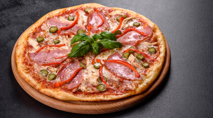 Delicious fresh crispy pizza from the oven with ham and Bulgarian pepper