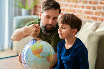 Father and son looking for a travel plan