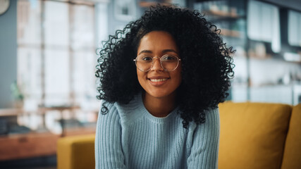 Portrait of a Beautiful Authentic Latina Female with Afro Hair Wearing Light Blue Jumper and...