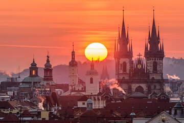 Fototapeta premium The sun sets up over the Church of Our Lady before Týn in Prague.