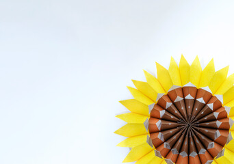 Sunflower made of paper bags on light background.