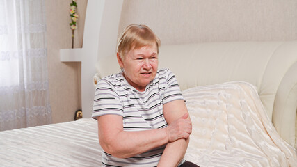 Elderly woman in the bedroom doing exercises
