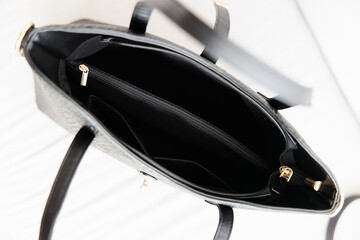 open women's black leather shoulder bag top view