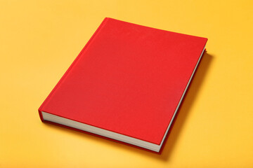 Book with red cover on yellow background