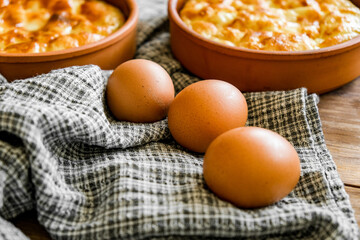 Omelet of chicken eggs in clay dishes. Healthy breakfast.