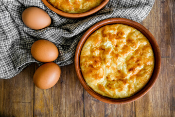 Omelet of chicken eggs in clay dishes. Healthy breakfast.