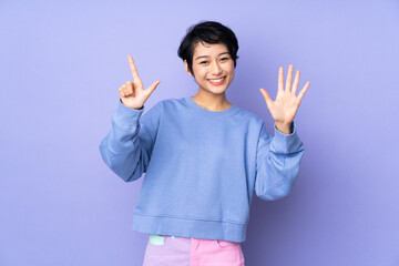 Young Vietnamese woman with short hair over isolated purple background counting seven with fingers