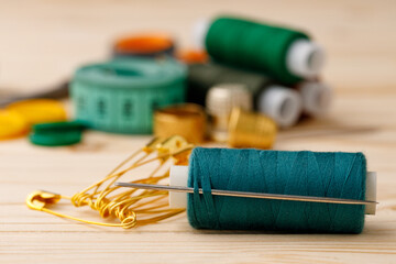 Threads and sewing accessories on wooden table