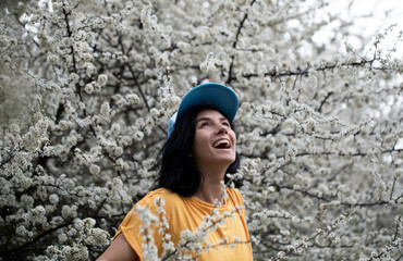portrait of a woman. Flowers background. Woman smile. 